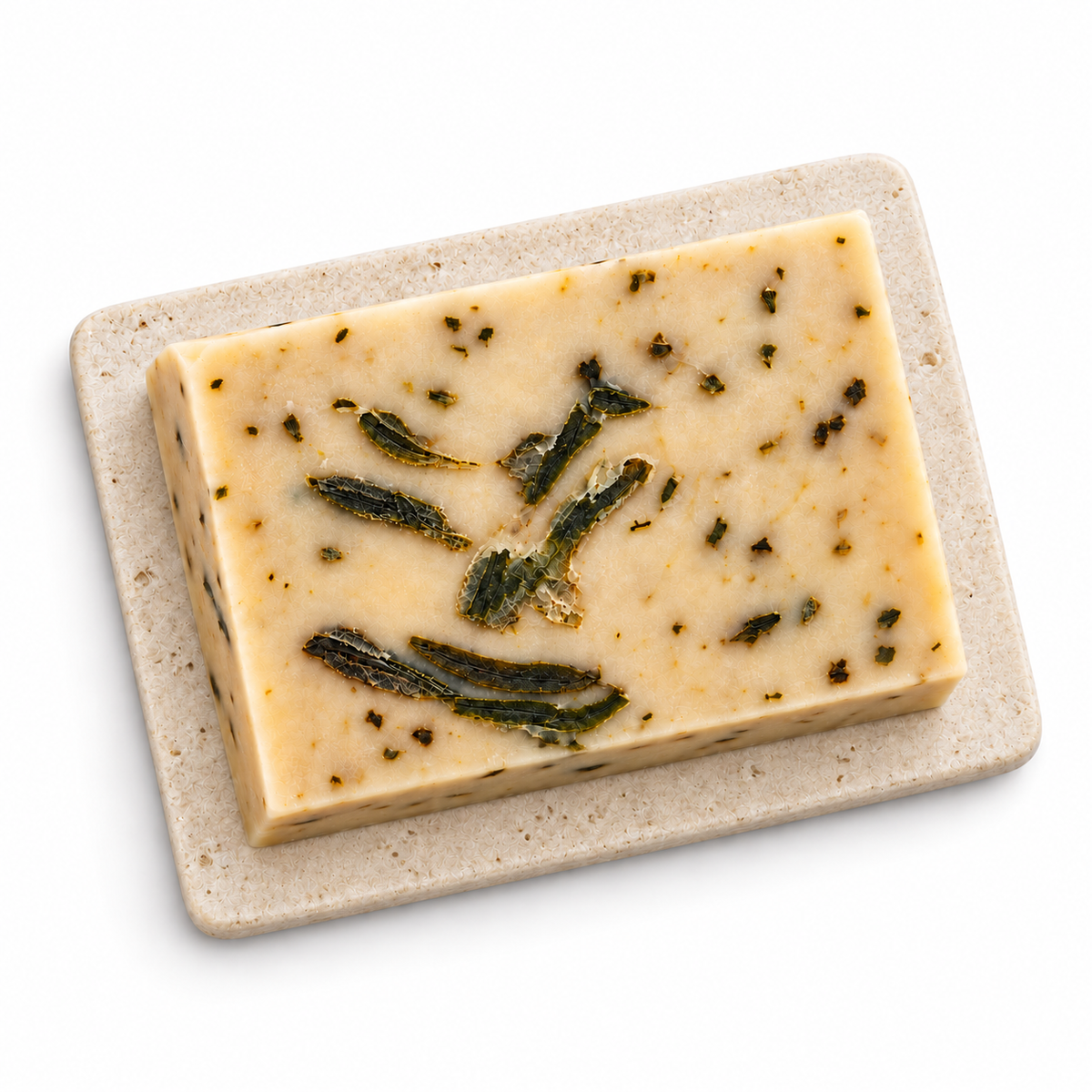 Overhead view of rectangular cream Miracle Leaf botanical soap on a flat pale stone tray against a white background