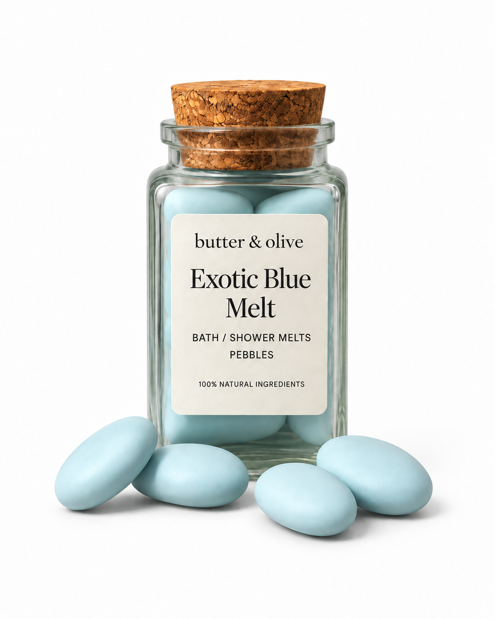 Exotic Blue bath and shower melt pebbles in a clear glass jar on a white background, with the butter & olive logo