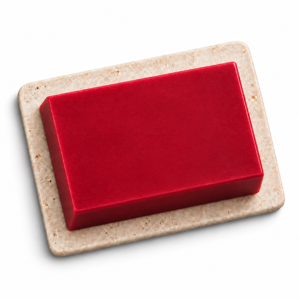 Rouge Royal smooth red soap bar on a pale speckled soap tray against a clean white background